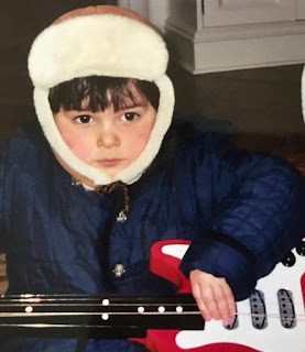 Childhood picture of Spencer Barnett with the guitar