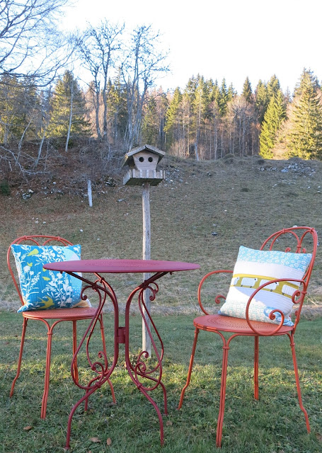 Teal and mustard yellow quilted cushions - In the garden