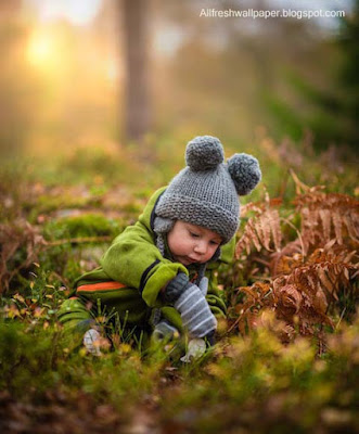 wearing-green-dress-baby-finding-playing-with-grass