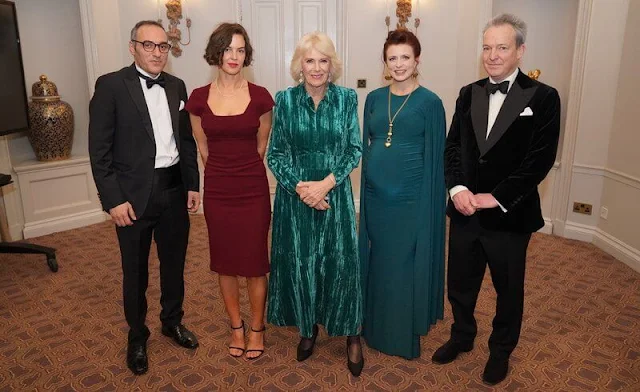 Queen Camilla wore a green crushed velvet elegant maxi dress by Me+Em. Van Cleef and Arpels Alhambra diamond earrings