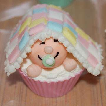 Baby shower cupcake with small baby under towel accessory