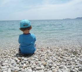 Boy sitting on the beach at Brighton
