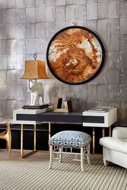 beautiful stone wall living room with gold and modern art vignette