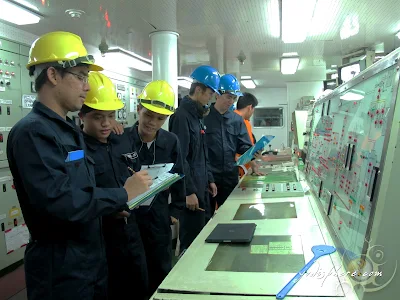 Cadets and officers at the ship engine control room