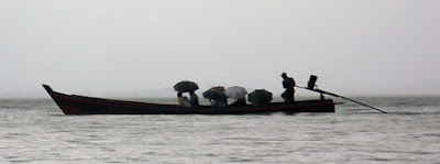 longtail boat in the rain