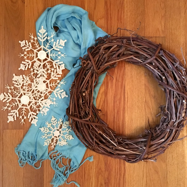 Use a scarf and dollar tree ornaments to make this Winter Snowflake Grapevine Wreath!