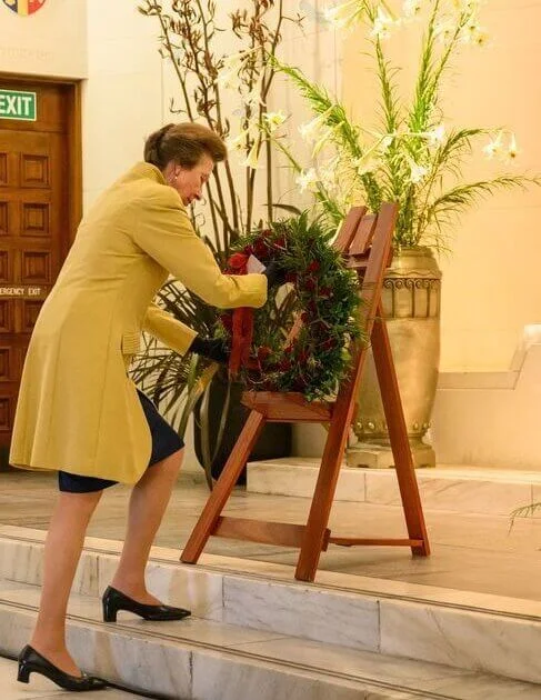 Princess Anne wore a red shirt dress and a beige tweed jacket and yellow and navy blue wool cashmere coat. Gold brooch