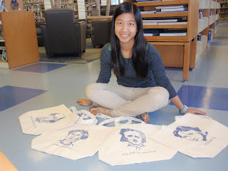 A photo of Yunhan sitting with her totes in front of her.