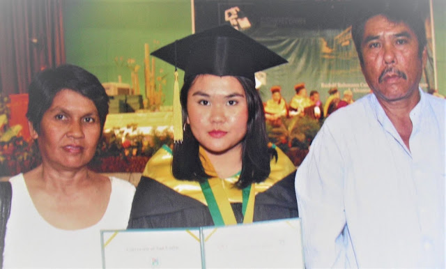 Jonnah (center) with her parents during her graduation