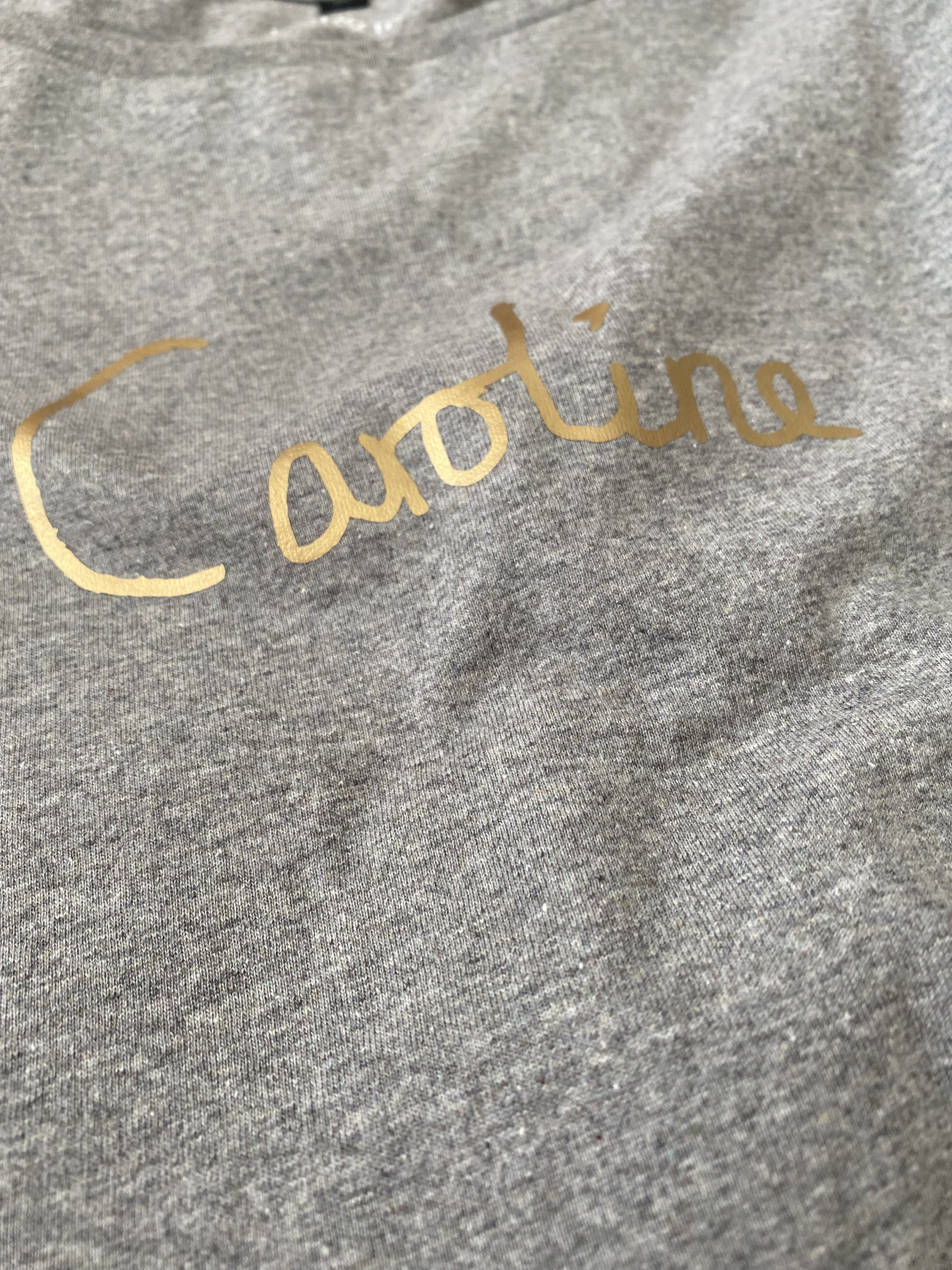 Close up of grey t-shirt from Bell and Fox, Brighton with bespoke gold print