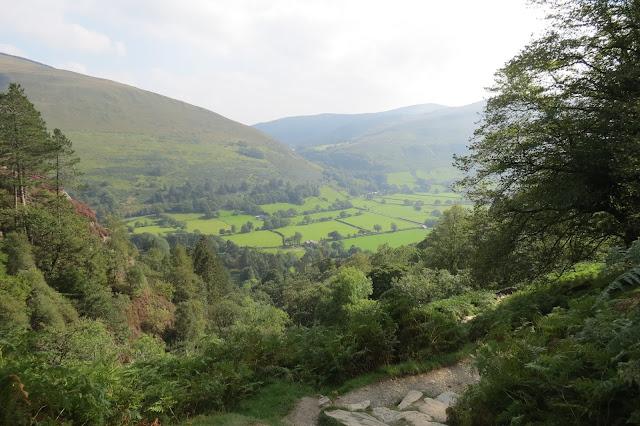 Back on the stone path down, the valley below now clear of mist.