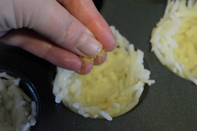 Seasoning the potato nests with seasoning salt.