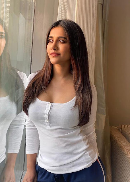 Nabha Natesh looks adorable in a cute pose, dressed in a white outfit