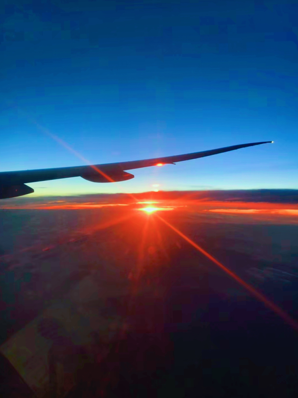 Great sunset views above the clouds outside the plane window