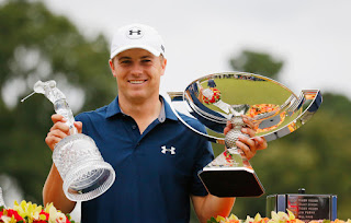 Jordan Spieth holding FedEx Cup and Tour Championship Trophies