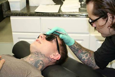 A Guy Gets His Face Tattoed