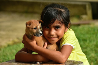 Image: Little girl hugging puppy, by LATUPEIRISSA on Pixabay