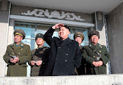 North Korean leader Kim Jong Un (center) watches flight training as he . (kim jong un north korea )