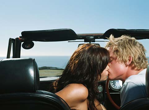 young couple kissing in rain. young couple kissing in the