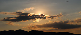 The sun emerging from behind some clouds