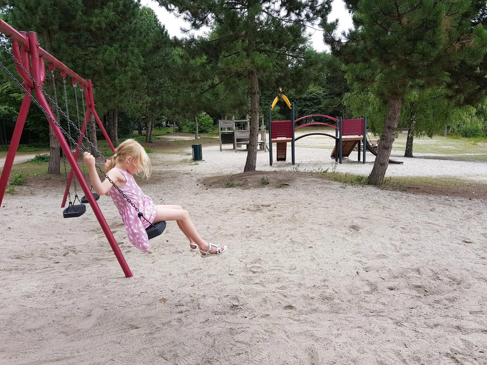 A girl on a swing in a playground