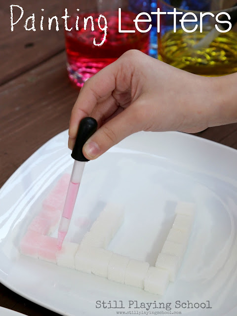 Painting letters made of sugar cubes invites kids to practice fine motor skills in several ways!