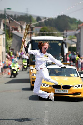 Torchbearer Nadine Struijk carries the Olympic Flame