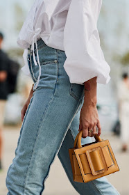 25 Best Mini Bags — Street style outfit inspiration with a white puff-sleeved top, jeans, and tan Boyy bag