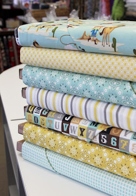 Stack of Sasparilla fabric from Riley Blake