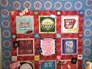 University of Arkansas and Alpha Omega Pi t-shirts framed in light prints, sashed with red.