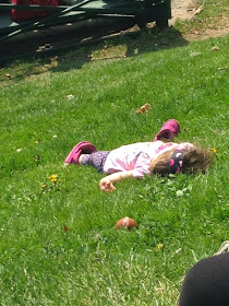 little girl laying in the grass