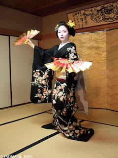 Maiko 4, dancing with decorative paper fans, Gion, Kyoto