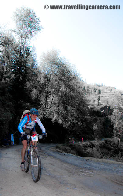 First Riding stretch on second day of MTB 2010 - Shainj to Chhaila : Posted by VJ SHARMA at www.travellingcamera.com : Hope you have already seen photographs of Flag-Off, First Day Rides, Morning Preparations on Second Day and some glimpses of MTB Himachal 2010... Here are few Photographs of first Stretch between Shainj and Chhaila...Here are few riders who are leading the first stretch which started just after Shainj Village... Unexpectedly weather was clear on second day and everyone was happy and all the riders were excited about the Hike & Bike session after completion of first Stretch at Chhaila Turn... Here is a Photograph clicked on the way from Shainj to Chhaila... Sharing this photograph to just give an idea about the hills and roads we traversed on second day... It doesn't mean that whole stretch on second day was like this... A reflection of the walking rider.. This is clicked in the side mirror of our van which was moving towards the next halt near a Bridge next to Shainj... Actually it was a free ride from the camp-site till a Bridge(don't know the name of that place..)Bikers on lovely road surrounded by beautiful mountains in Shainj region... it was amazing place but unfortunately we couldn't afford to stop at this place... So most of the photographs have been clicked from moving car...This road was under construction and here are the hard working folks who are going to work there to make our lives easy and more comfortable... Real engineers of India !!!There were many water streams on the way and here is one silhouette  of a rider moving towards first goal without any care about various types of obstacles on the way...Here is Rider No 13 crossing the same water stream... I have lot of photographs of various riders at same spot and planning to have separate post with all those Photographs in near Future... Keep watching the same place to check out more photographs here...So finally we reached Chailla Turn and this was the destination for first stretch for second day.. Now everyone is having some snacks and juice to gear up for Hike & Bike session of 12 kilometers....One of the rider just reaching the final line of first Stretch and folks in the background are noting down the time... There were three timers to ensure that correct timings have been noted for all the riders...Here comes another rider to reach the final destination and have some rest for next stretch... During next Stretch everyone had to trek some mountains with their bikes ... It was really hard and some of them had to carry bikes weighing 21 Kgs... Their were only few bikes which had weight around 7-10 kgs and these cost more than 2 Lacs... (Please leave a comment in case this information is not correct.. coz I am not 100% sure about these figures)Here is a group of riders having some chit-chat during rest session at Chailla Turn...I think he is sad about the fact that he is leaving MTB today.. He was only for first two days which they called Environmental Ride...A part of the MTB Himachal Gang taking rest in bright sunlight which was very important on chilly hills of Himachal Pradesh...Bikes : Now its our turn... Carry us forward... Check out the same place for photographs of trekking riders by carrying their bikes on shoulders... 