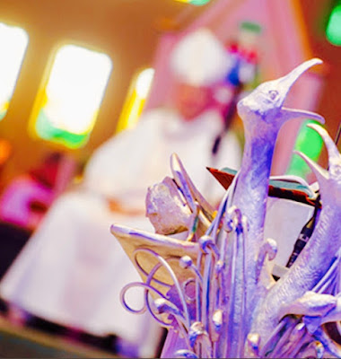 Image (cropped) from the Mass on May 1st, 2014, at the Catholic Metropolitan Cathedral of Christ the King, to celebrate the "installation" of His Grace The Most Rev. Malcolm McMahon OP as the ninth Archbishop of Liverpool (in background); foreground aspect showing the Rice/Riley "Sea Eagles Lectern". Taken from the Flickr album created and publicly shared by © Mazur/catholicnews.org.uk under the stated free to use and adapt attribution of the Creative Commons Non-commercial Share Alike Generic 2.0 policy [CC-BY-NC-SA-2.0] 