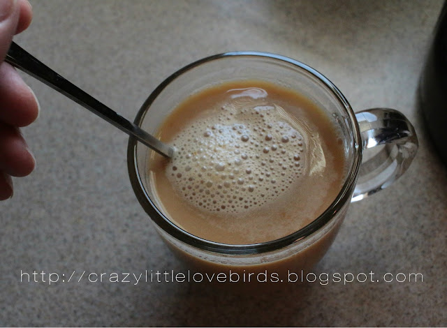 coffee being mixed in glass cup