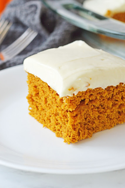 piece of cake on a white plate with gray background.