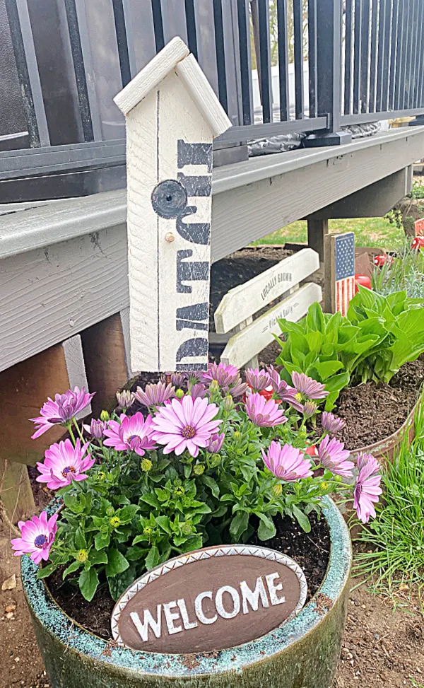 garden stake birdhouse in purple flower pot