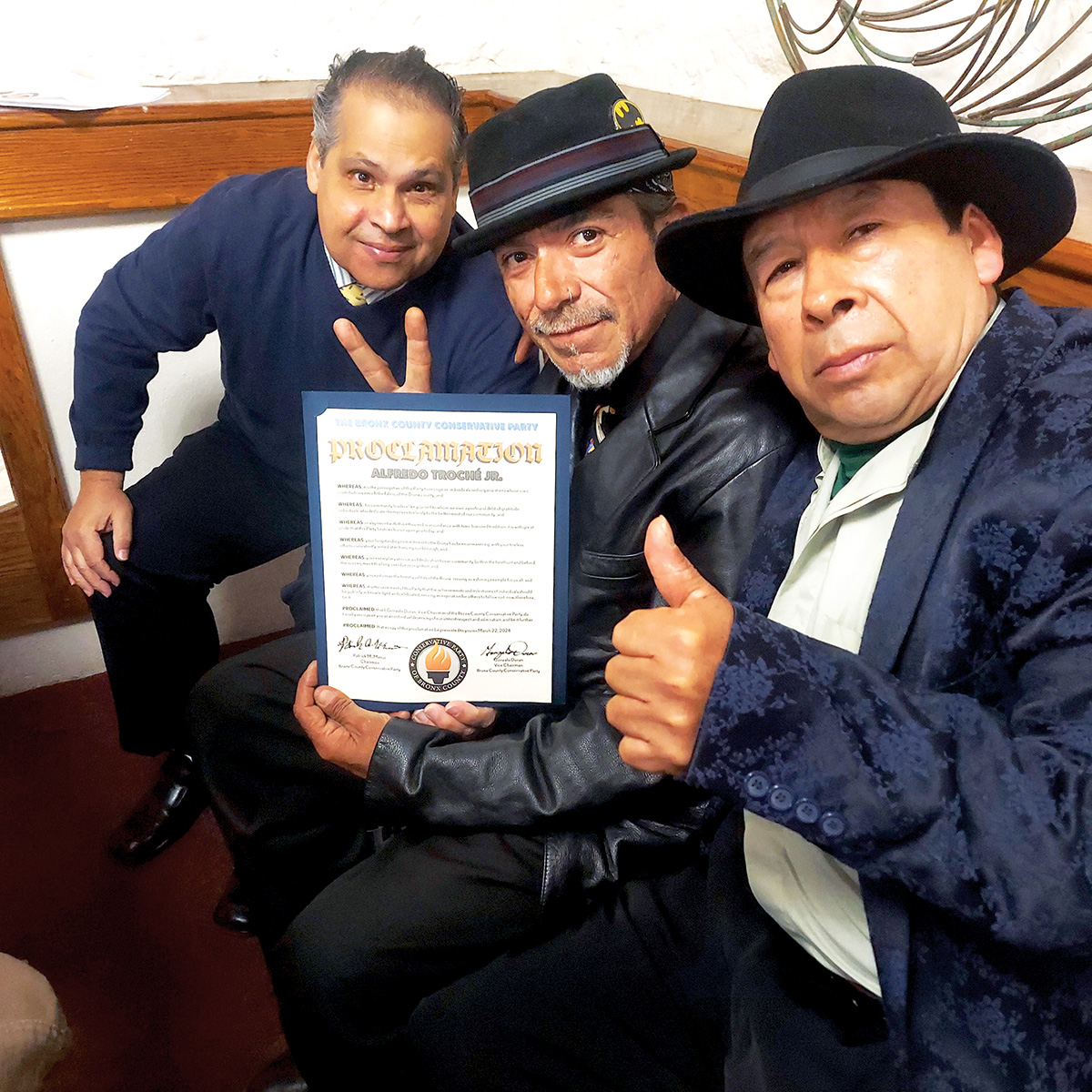 At The Bronx Conservative Party’s monthly meeting are (Left to Right): Belmont resident Joe Padilla, subway hero Alfred Troche holding his proclamation with his friend Jorge Castelan. -Photo by David Greene