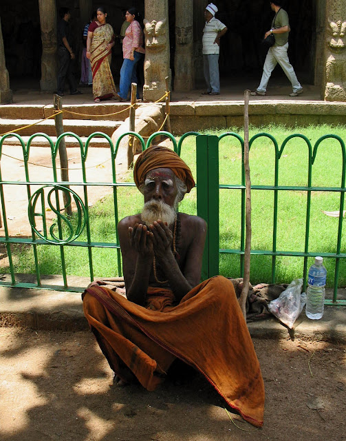 old man beggar in saffron robes