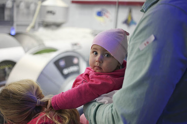 A family tours the astronaut training facility at the Johnson Space Center in Houston
