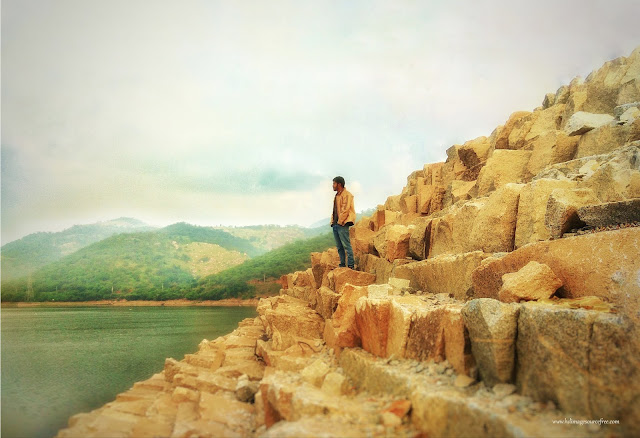 men at lake side view