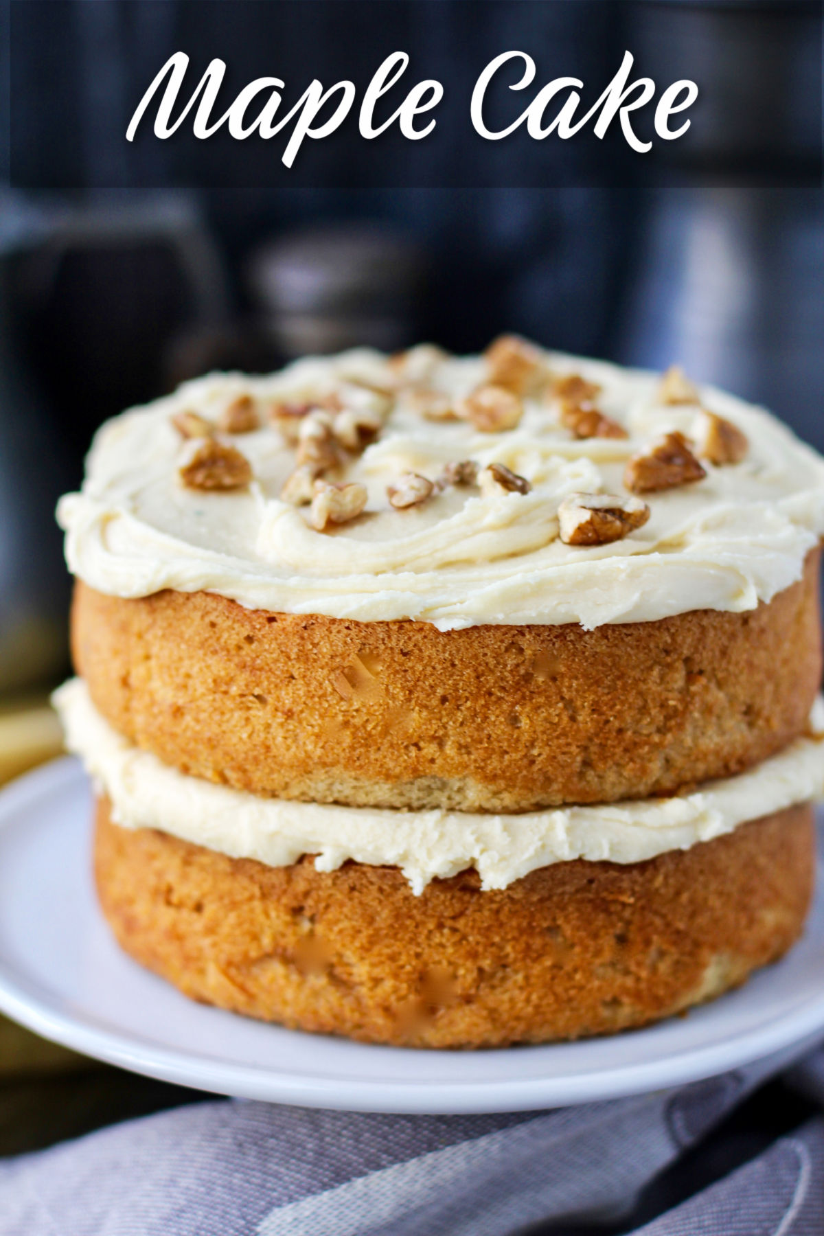 Maple Cake on a cake stand with pecans.