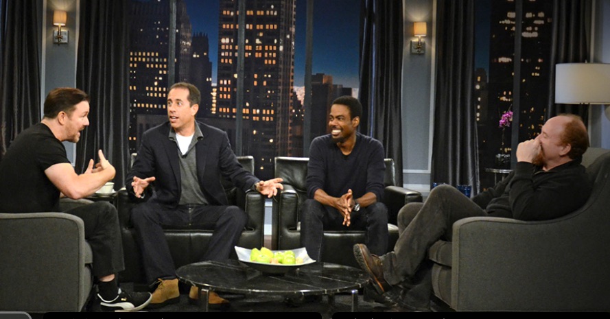 Ricky Gervais, Jerry Seinfeld, Chris Rock, and Louis C.K. in plush chairs talking and gesturing