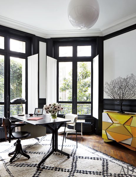 Stefano Pilati of Zegna's Paris duplex with  black and white home office with an olivetti desk and beni ourain moroccan carpet rug