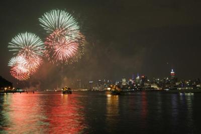 Fireworks explode over the Hudson River and the skyline