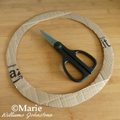 Circle of thick card from box with scissors