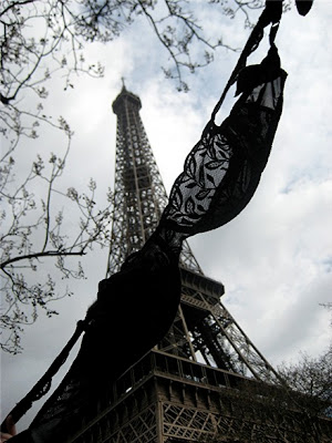 Olga the Traveling Bra close up and personal with the Eiffel Tower in Paris France