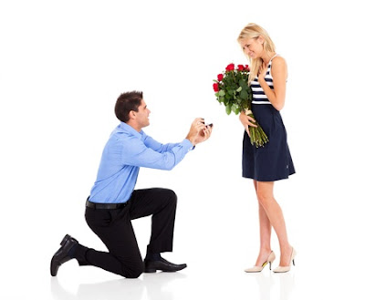 young man down on his knee proposing to girlfriend