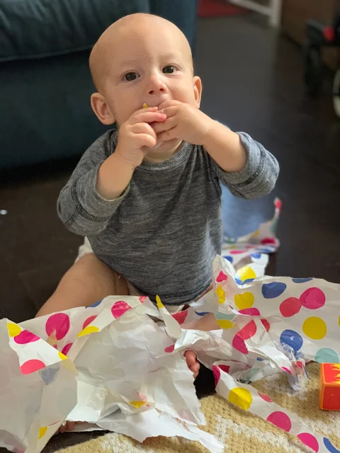Baby Boy eating spotty wrapping paper