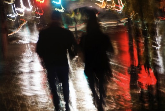 couple holding hands in rain. the rain holding hands.